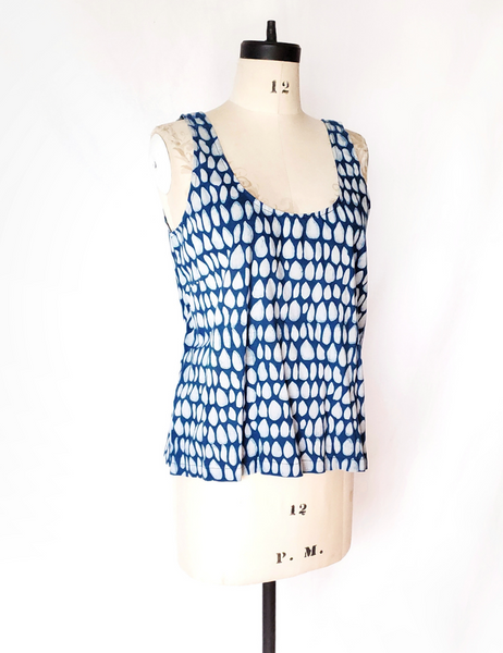 Mannequin wearing white and indigo butti tank top. Scoop neck.