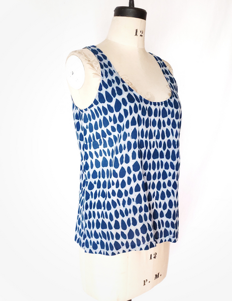 Mannequin wearing white and indigo butti tank top. Scoop neck.