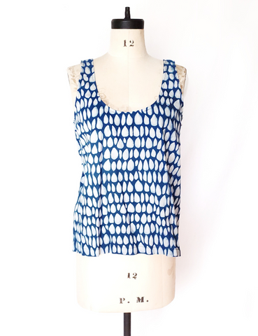 Mannequin wearing white and indigo butti tank top. Scoop neck.